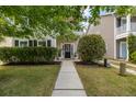 Inviting front yard with lush green grass, trimmed hedges, and a walkway leading to the covered entryway at 1817 Towne St, Johns Island, SC 29455