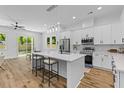 Bright kitchen features an island with bar seating, modern stainless appliances, and natural light streaming in from the patio doors at 1917 Jason St, North Charleston, SC 29406