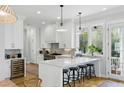 Modern kitchen with stainless steel appliances, breakfast bar, and ample natural light at 2 Piedmont Ave # A, Charleston, SC 29403