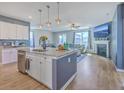 Open-concept kitchen with island seating flowing into a cozy living area with a fireplace and TV at 215 Shortmarsh St, Summerville, SC 29486