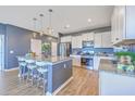 Bright kitchen featuring a large island with seating, granite countertops, and stainless steel appliances at 215 Shortmarsh St, Summerville, SC 29486
