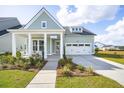 Charming exterior with a two-car garage, covered porch and manicured lawn at 220 Callibluff Dr, Summerville, SC 29486