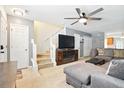 Comfortable living area featuring soft carpet, a ceiling fan, and a staircase to upper floor at 224 Jackson St, Goose Creek, SC 29445