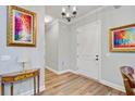Elegant hallway featuring hardwood floors, neutral walls, and decorative artwork enhancing the ambiance at 225 Ridge Rd, Ridgeville, SC 29472