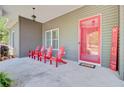Inviting front porch with vibrant red seating and a charming welcome sign near the front door at 225 Ridge Rd, Ridgeville, SC 29472