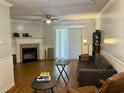 Spacious living room with a fireplace, ceiling fan, and sliding glass doors at 2314 Treescape Dr # 2406, Charleston, SC 29414