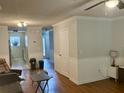 Open living room with wood floors, white wainscoting, and a view to the kitchen at 2314 Treescape Dr # 2406, Charleston, SC 29414