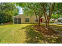 Nice view of the back of this charming tan home, with a grassy yard and a screened-in porch at 247 Darcy Ave, Goose Creek, SC 29445