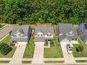 Aerial view of homes in a suburban neighborhood with tree-lined streets at 259 Weeping Cypress Dr, Moncks Corner, SC 29461