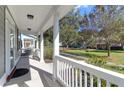 Inviting front porch featuring white columns and railing, offering a pleasant outdoor space overlooking the lawn at 2909 Swamp Sparrow Cir, Johns Island, SC 29455