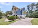 Two-story blue home with a spacious paved driveway and mature palm trees at 2919 Zachary George Ln, Johns Island, SC 29455