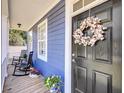 Charming front porch with rocking chairs, flowers, and a decorative wreath at 2919 Zachary George Ln, Johns Island, SC 29455