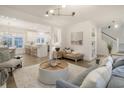 Open-concept living room boasts hardwood floors, modern lighting, and stylish furnishings at 303 S Ladd Ct, Charleston, SC 29492