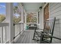 Inviting front porch features rocking chairs, a bench, and a relaxed atmosphere at 303 S Ladd Ct, Charleston, SC 29492