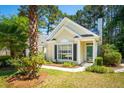 Inviting home with lush landscaping and a manicured lawn providing shade and curb appeal at 328 Fern House Walk, Mount Pleasant, SC 29464