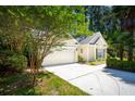 This home boasts an attached garage and driveway, complemented by a lush green lawn and mature landscaping at 328 Fern House Walk, Mount Pleasant, SC 29464