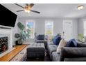 Inviting living room with gray sofa and ottoman, fireplace with mounted TV and bright windows at 352 Clayton Dr, Charleston, SC 29414