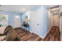 Inviting entryway features light blue walls, wood floors, and decorative mirror and table at 402 Woodward Blvd, Summerville, SC 29483