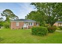 Attractive brick home with a neat lawn and mature landscaping at 406 Annette Dr, Goose Creek, SC 29445