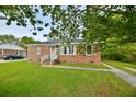 Well-maintained brick home with a green lawn and charming front entrance at 406 Annette Dr, Goose Creek, SC 29445