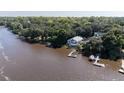 Aerial view of waterfront home with private dock and beautifully landscaped surroundings at 4940 Lambs Road Rd, North Charleston, SC 29418