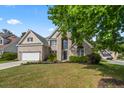 Beautiful two-story home with lush lawn and mature tree providing curb appeal at 5413 Barnsley Dr, North Charleston, SC 29420