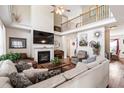 Spacious living room features soaring ceilings, fireplace, hardwood floors, and ample natural light at 5413 Barnsley Dr, North Charleston, SC 29420
