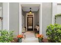 Warm and welcoming entryway with a pendant light, bench seating, and decorative potted flowers at 656 Coleman Blvd # 405, Mount Pleasant, SC 29464