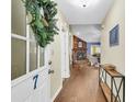 Inviting foyer featuring hardwood floors, a view of the living room fireplace, and stylish decor at 7 Sconesill Ln, Charleston, SC 29414