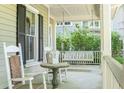 Relaxing front porch featuring rocking chairs and a swing perfect for enjoying the outdoors at 707 Royall Ave, Mount Pleasant, SC 29464