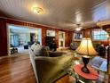 Inviting living room featuring hardwood floors, wood paneling, and comfortable seating at 922 Dill Ave, Charleston, SC 29412