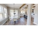 Bright dining area with a round white table and a view of the modern kitchen at 966 Tiger Loop, Saint Stephen, SC 29479
