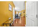 Inviting foyer with hardwood floors and an open view to the dining area and kitchen at 9759 Seed St, Ladson, SC 29456