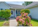 Charming front porch is adorned with a beautiful rose bush at 101 Old Tree Rd, Goose Creek, SC 29445