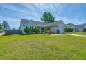 Well-maintained single-story home showcasing lush green lawn and inviting curb appeal at 101 Old Tree Rd, Goose Creek, SC 29445