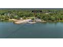 Waterfront property aerial view with direct access, highlighting its unique location with a dock and mature trees at 1010 Black Oak Rd, Bonneau, SC 29431