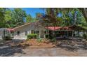Inviting home with a red roof, featuring covered parking, complemented by a neatly landscaped front yard at 1010 Black Oak Rd, Bonneau, SC 29431
