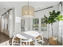 Bright dining room with modern chandelier, natural light, and views of the outdoor scenery at 1021 Sagegrass Street, Summerville, SC 29485