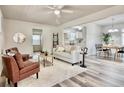 Bright and airy living room seamlessly connects to dining and kitchen, with stylish decor and wood-look flooring at 1232 Hawthorne Cir, Hanahan, SC 29410