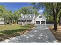 Attractive home featuring a long driveway, a two-car garage, and mature trees at 1260 Old Whitesville Rd, Moncks Corner, SC 29461