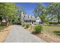 Inviting home with a classic design, featuring a well-manicured front yard and a gravel driveway at 1260 Old Whitesville Rd, Moncks Corner, SC 29461