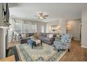 Spacious living room features a cozy fireplace, large windows, and stylish decor, creating an inviting atmosphere at 127 Surfbird Rd, Summerville, SC 29486
