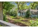 Charming single-story home with lush landscaping, colorful garden, and a decorative black fence at 1316 Wichman St, Walterboro, SC 29488