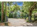 Quaint single-story home featuring lush landscaping, a circular driveway, and ample parking at 1316 Wichman St, Walterboro, SC 29488