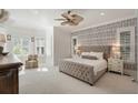 Bright and airy bedroom with patterned accent wall, plush carpeting, and lots of natural light at 1505 Rivertowne Country Club Dr, Mount Pleasant, SC 29466