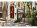Elegant entrance featuring a polished wood door, marble steps, and wrought iron gate at 17 Wentworth St, Charleston, SC 29401