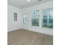 Bright living room with recessed lighting, vinyl floors, and access to a door and backyard at 2009 E Patterson Pt, Hanahan, SC 29410