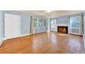 Spacious living room featuring hardwood floors, a cozy fireplace, and ample natural light at 210 Padgett Loop, Walterboro, SC 29488