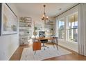 Bright and spacious study with large windows, modern shelving, and hardwood floors at 213 Clearpath Dr, Summerville, SC 29486