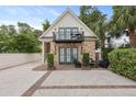 Charming carriage house featuring brick accents, an upper level balcony, and private parking at 221 Ashley Ave # Abc, Charleston, SC 29403